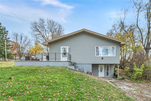 rear view of house featuring a lawn