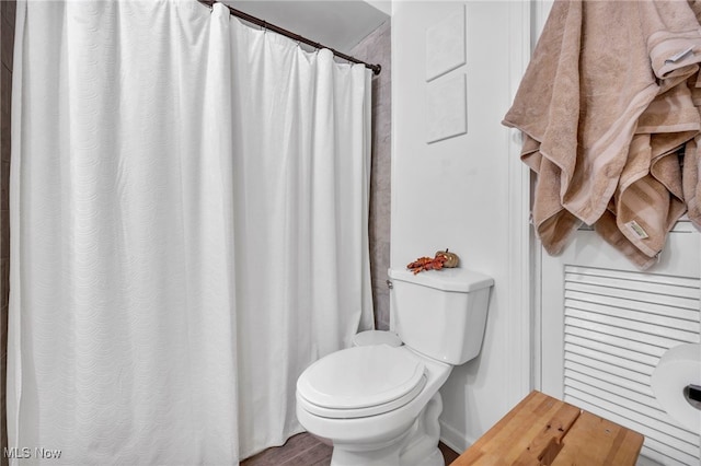 bathroom with hardwood / wood-style floors and toilet