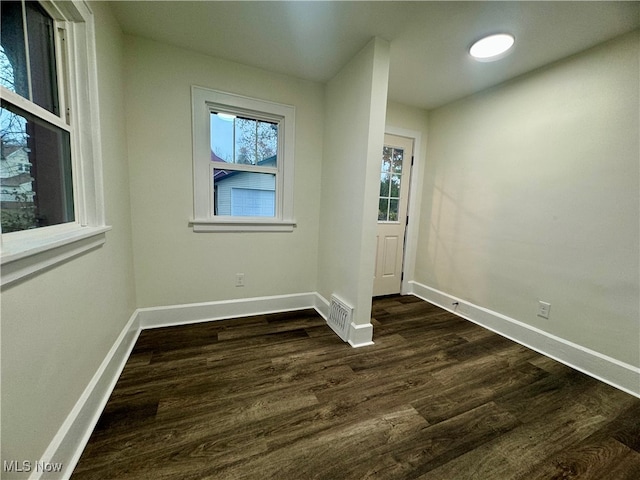 spare room with dark hardwood / wood-style flooring