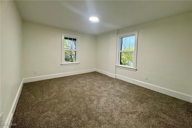 carpeted empty room with plenty of natural light