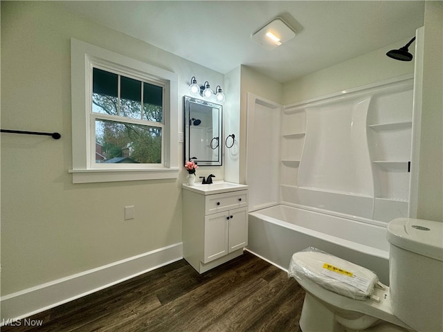 full bathroom featuring vanity, toilet, wood-type flooring, and bathtub / shower combination