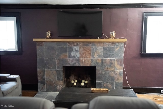 interior details featuring a fireplace and crown molding