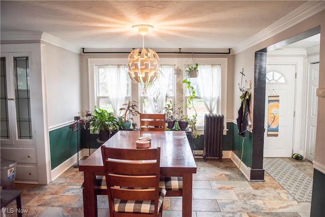 dining area featuring radiator heating unit and ornamental molding