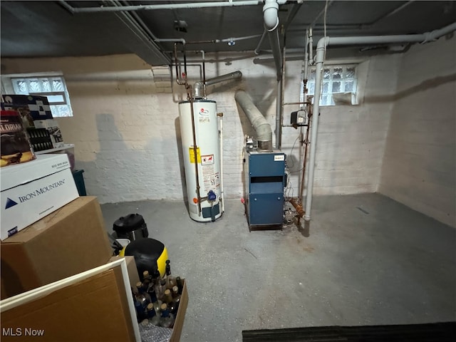 basement with gas water heater and a healthy amount of sunlight