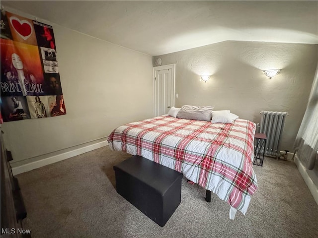 carpeted bedroom featuring radiator and vaulted ceiling