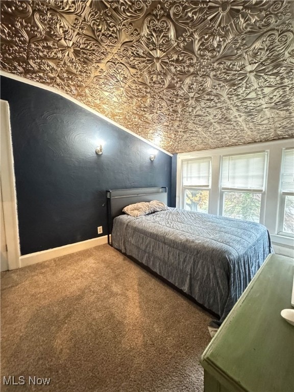 bedroom with carpet flooring and lofted ceiling