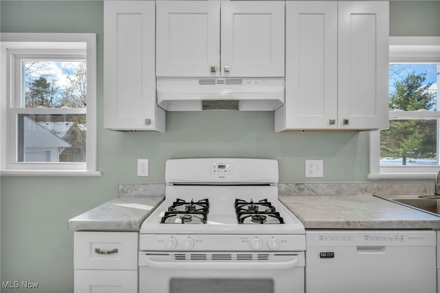 kitchen featuring white cabinetry, sink, and white appliances