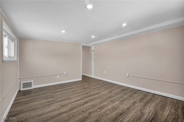 empty room with dark hardwood / wood-style flooring