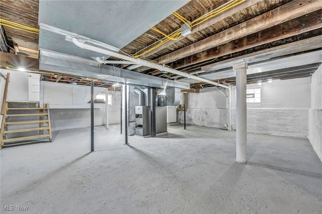 basement featuring heating unit and washer / dryer