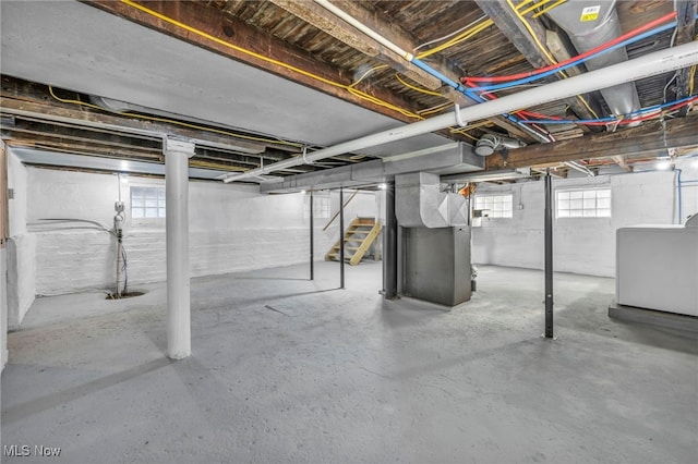 basement featuring washer / clothes dryer and heating unit