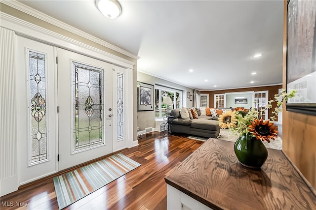 foyer featuring ornamental molding and dark wood-type flooring