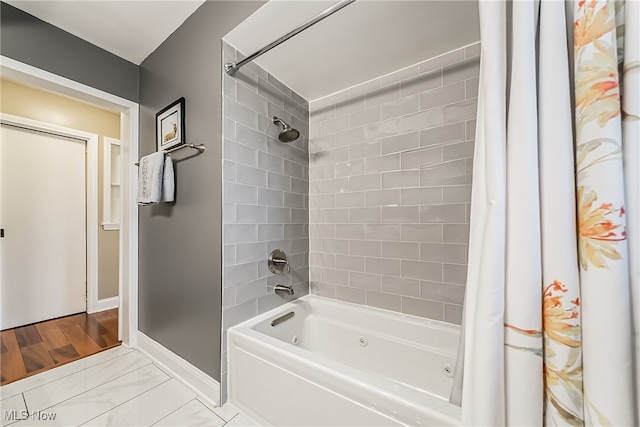 bathroom with shower / bath combination with curtain and wood-type flooring