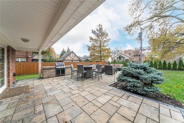 view of patio featuring area for grilling, an outdoor hangout area, and an outdoor kitchen