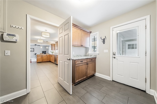 kitchen with dishwasher and light stone countertops