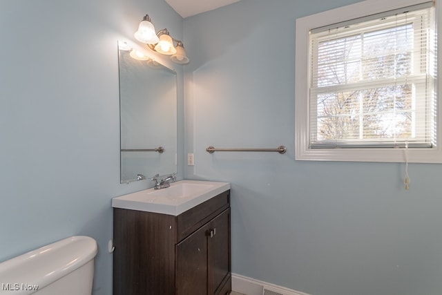 bathroom featuring vanity and toilet