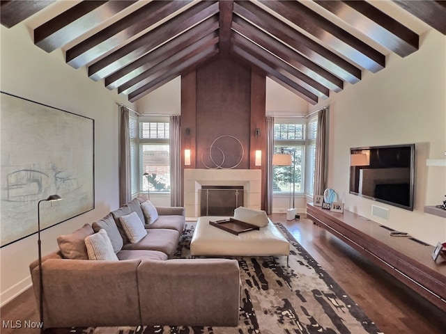 living room with vaulted ceiling with beams and hardwood / wood-style flooring