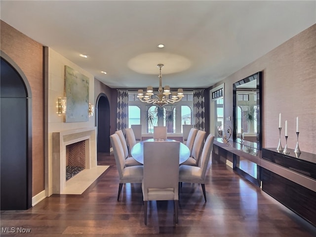 dining room featuring dark hardwood / wood-style floors, an inviting chandelier, and a wealth of natural light