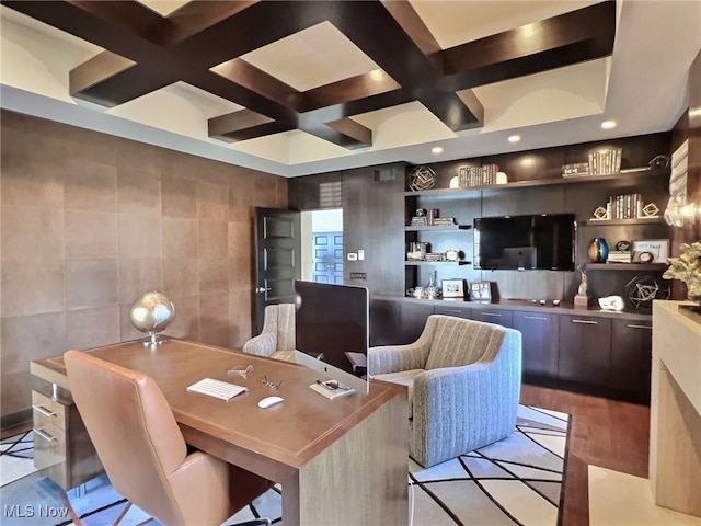 office with coffered ceiling, light hardwood / wood-style flooring, built in shelves, tile walls, and beam ceiling