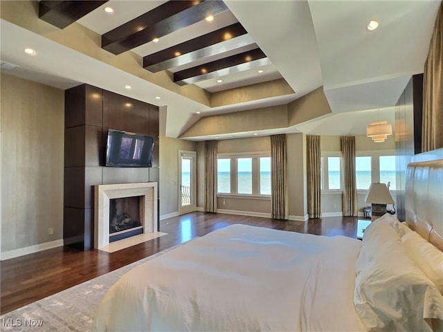 bedroom featuring beamed ceiling and dark hardwood / wood-style floors