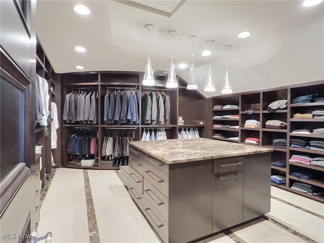 spacious closet featuring light tile patterned floors