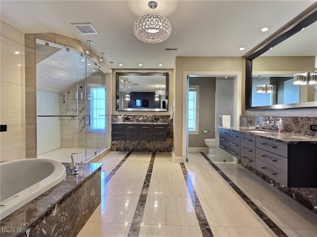 full bathroom with a chandelier, vanity, separate shower and tub, and toilet