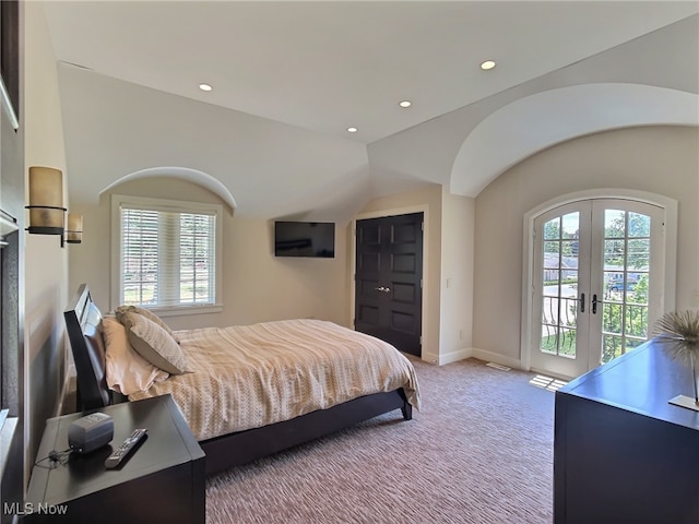 carpeted bedroom featuring vaulted ceiling, access to exterior, multiple windows, and french doors