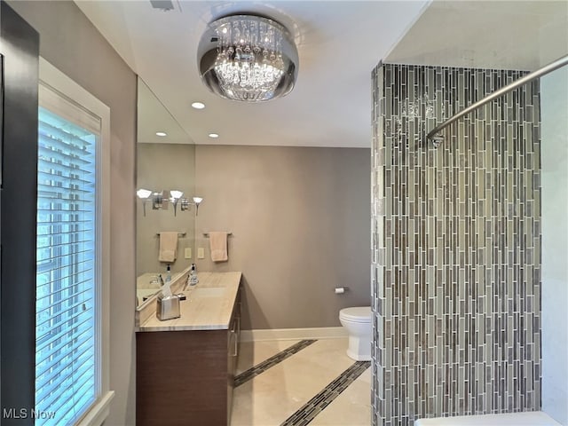 bathroom with vanity, toilet, and walk in shower