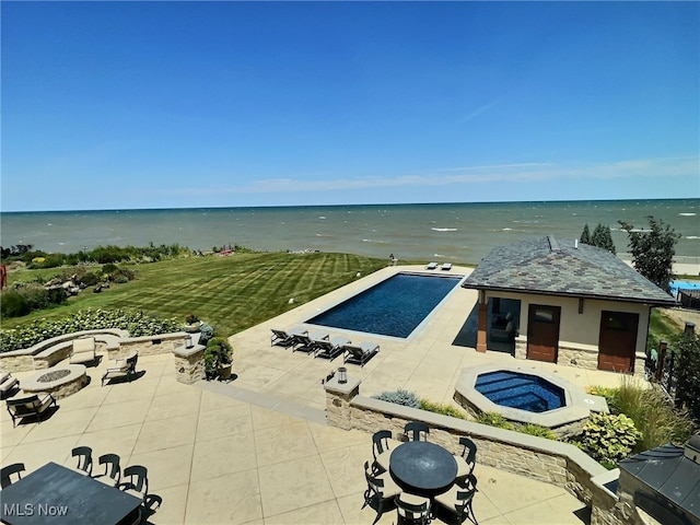 view of pool with a water view and an outdoor fire pit