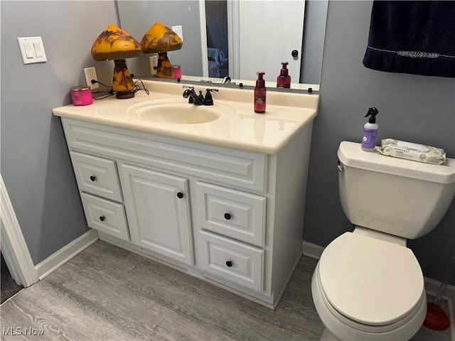 918 Ashmun Ave, Tallmadge, OH 44278 - bathroom with toilet, wood finished floors, vanity, and baseboards