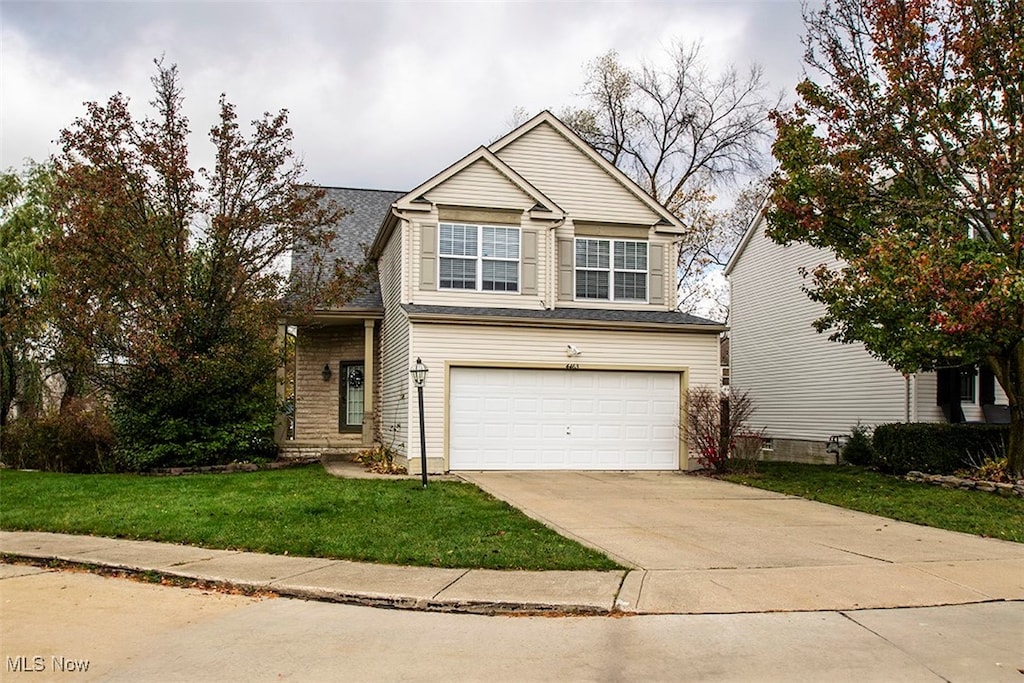 view of front facade with a front yard and a garage