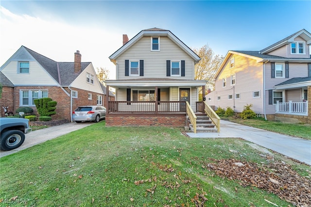 view of front of house with a porch and a front yard