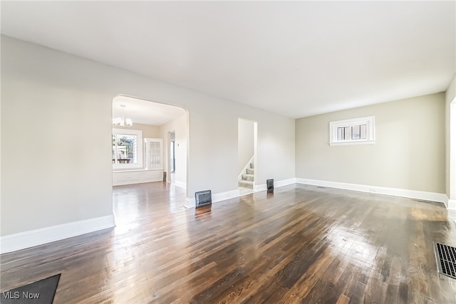 empty room with dark hardwood / wood-style flooring