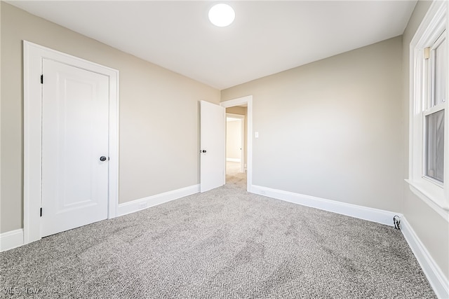 unfurnished bedroom with a closet and carpet