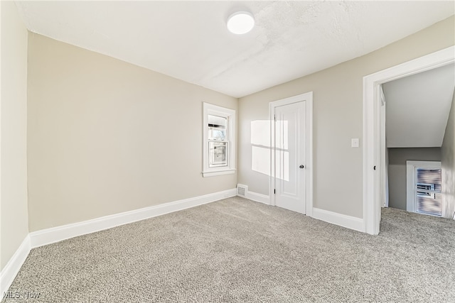 unfurnished bedroom with carpet and a closet