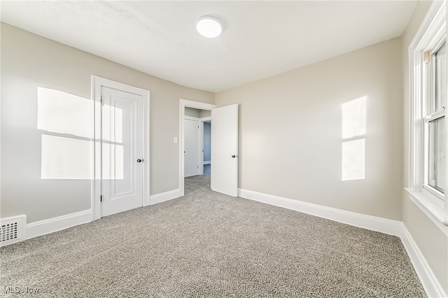 unfurnished bedroom featuring carpet flooring and a closet