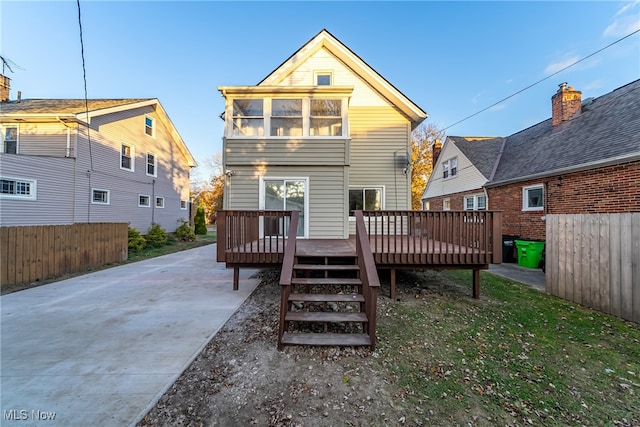 back of house featuring a deck