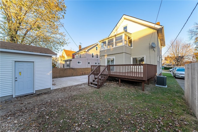 rear view of house with a patio, a deck, and cooling unit