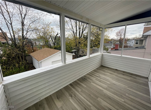 unfurnished sunroom with vaulted ceiling