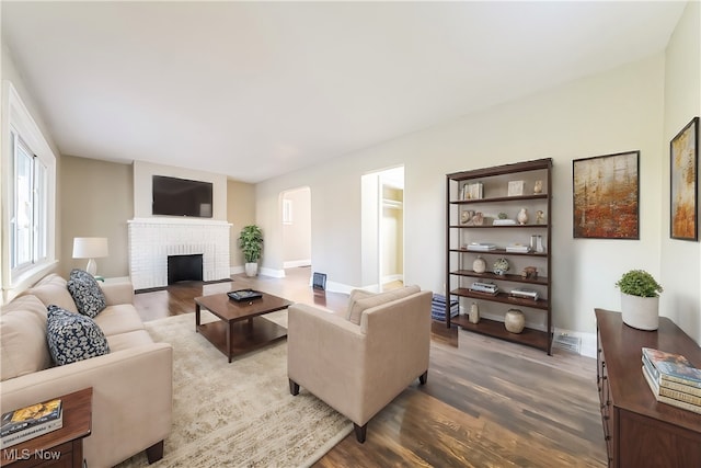 living room featuring a fireplace and hardwood / wood-style floors