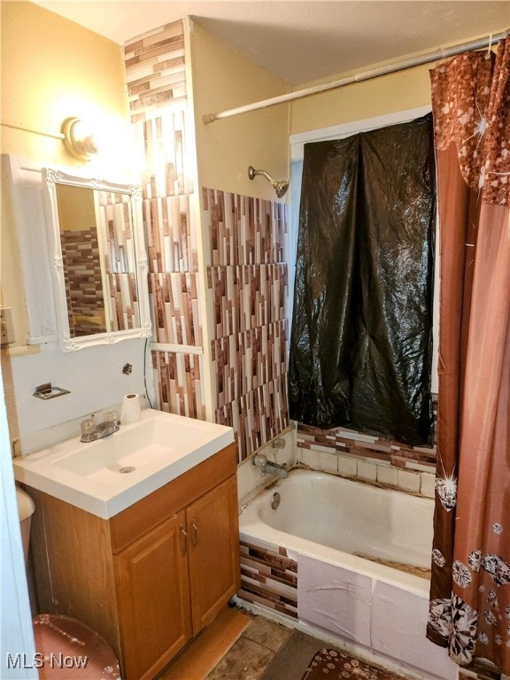 bathroom featuring tile patterned flooring, shower / bath combo, and vanity