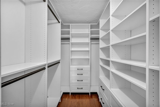 walk in closet featuring dark wood-type flooring