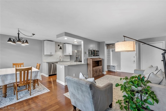 living room with hardwood / wood-style floors and a notable chandelier