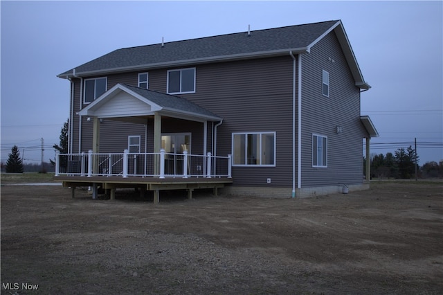 rear view of property featuring a deck