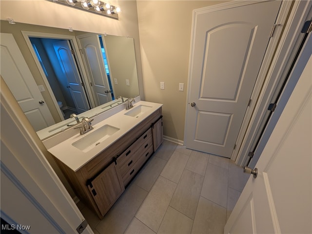 bathroom with tile patterned flooring and vanity