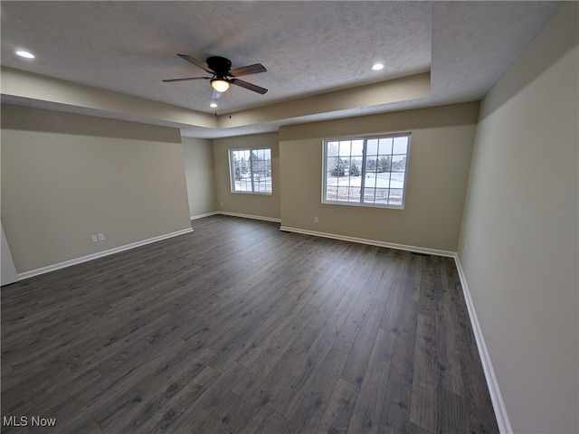 spare room featuring a textured ceiling, ceiling fan, and dark hardwood / wood-style floors