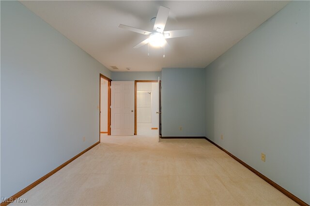 unfurnished room with light carpet, ceiling fan, and baseboards