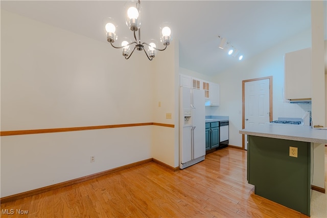 kitchen with a peninsula, white appliances, light wood-type flooring, and light countertops