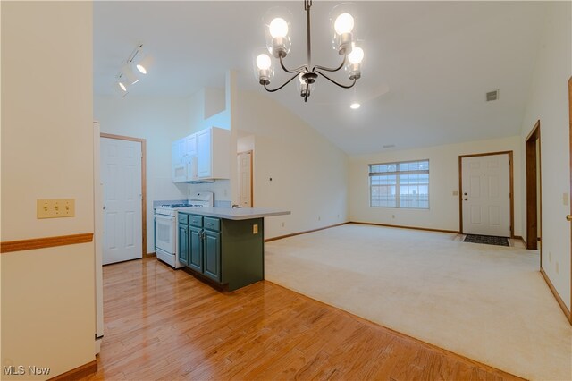 kitchen featuring white appliances, visible vents, baseboards, high vaulted ceiling, and a notable chandelier