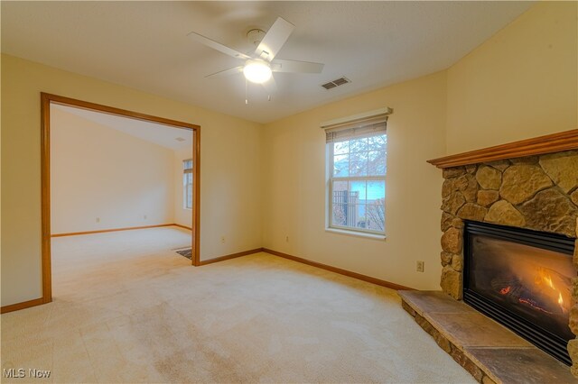 unfurnished living room with a fireplace, visible vents, light carpet, ceiling fan, and baseboards