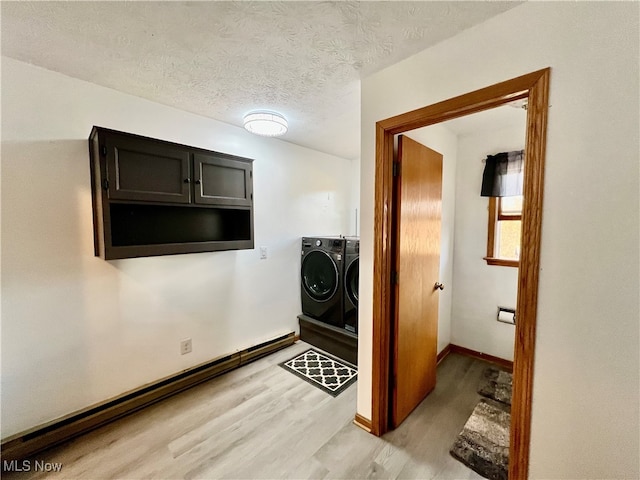 laundry area featuring wood-type flooring, a textured ceiling, and separate washer and dryer